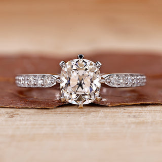 Old mine cushion cut diamond ring with pave setting ring.
