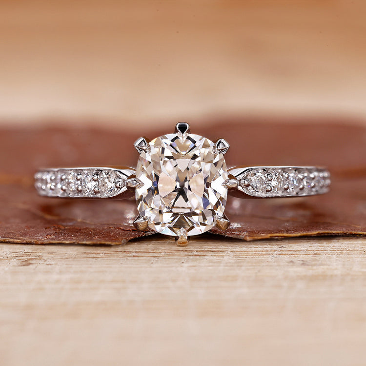 Old mine cushion cut diamond ring with pave setting ring.
