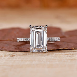 gold emerald cut engagement ring with pave band.
