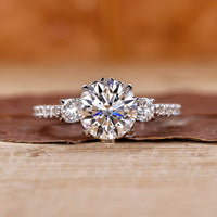 3 stone diamond ring with round cut diamonds in white gold.
