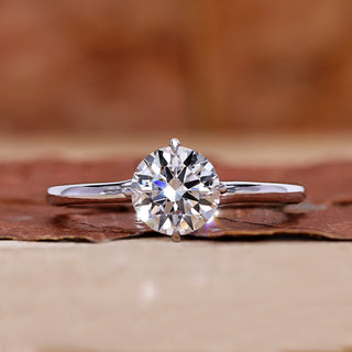 Round diamond engagement ring in white gold ring.
