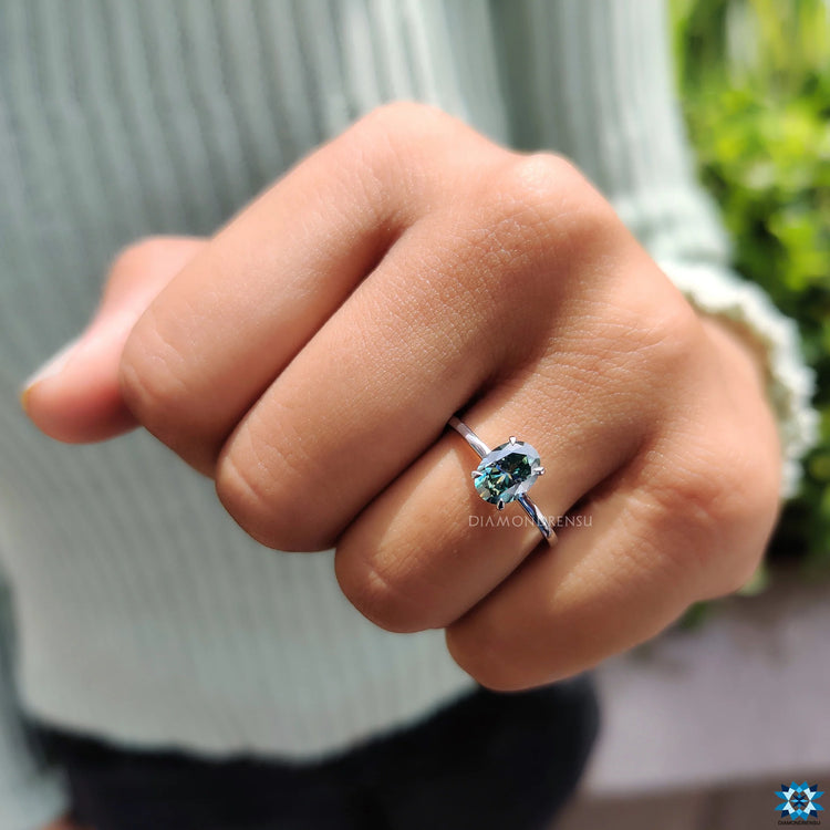 Diamondrensu Australia ring with an oval cut and unique greenish blue stone.
