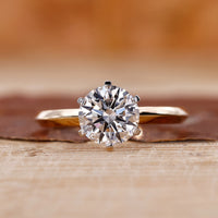 Yellow gold solitaire engagement ring with a round cut diamond centre.
