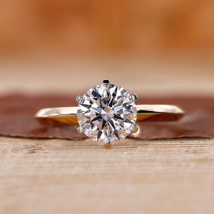 Yellow gold solitaire engagement ring with a round cut diamond centre.
