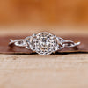 Solitaire diamond ring with Portuguese cut diamond and twist shank in white gold.
