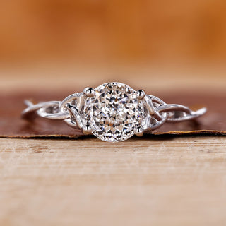 Solitaire diamond ring with Portuguese cut diamond and twist shank in white gold.
