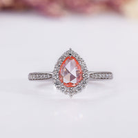 Pink diamond engagement ring with pear rose cut diamond in white gold.
