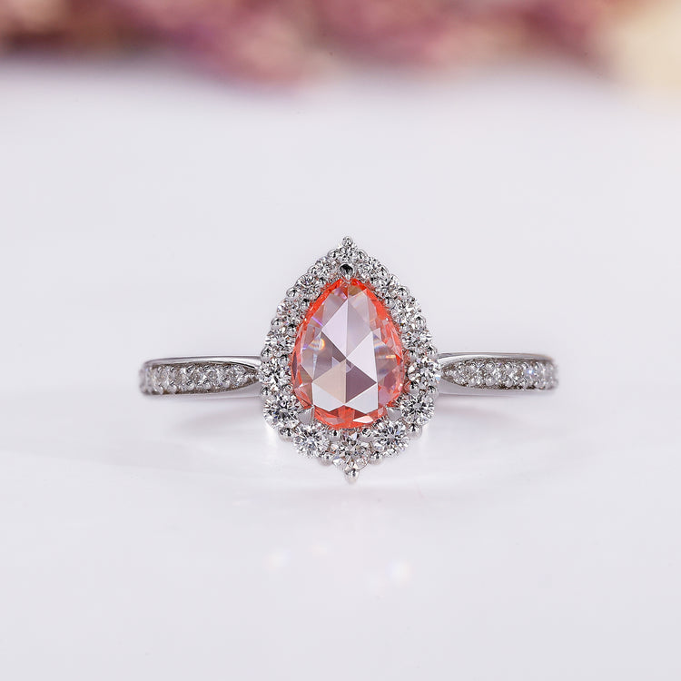 Pink diamond engagement ring with pear rose cut diamond in white gold.

