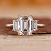 Three stone emerald cut ring with emerald diamond ring.

