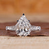 Vintage diamond ring with pear cut diamond and round side stones.
