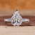 Vintage diamond ring with pear cut diamond and round side stones.

