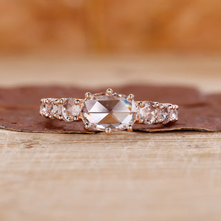Rose gold diamond ring with oval rose cut diamond and tapered pavé setting.
