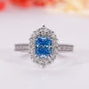 Blue diamond ring with radiant cut engagement ring.
