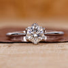 Round cut diamond ring in tulip setting ring.
