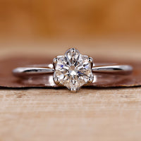 Round cut diamond ring in tulip setting ring.
