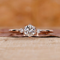 Three stone engagement ring with round diamond ring.

