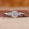 Portuguese cut diamond ring with round side stones in white gold.
