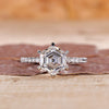 Pavé diamond ring with hexagon cut centre diamond in white gold.
