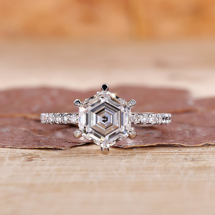 Pavé diamond ring with hexagon cut centre diamond in white gold.

