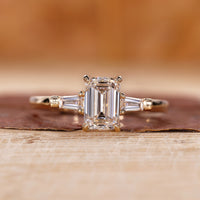 Emerald cut engagement ring with Tapered Baguette side stone.
