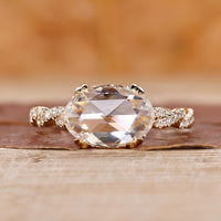 Oval rose cut diamond ring set in an east west design.
