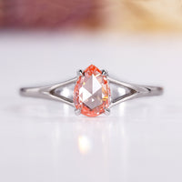 Split shank engagement ring with pear rose cut diamond in white gold.

