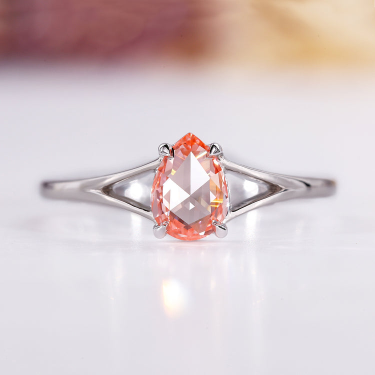 Split shank engagement ring with pear rose cut diamond in white gold.
