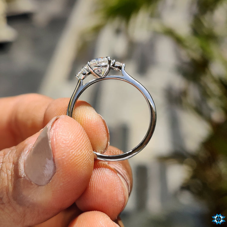 Three stone round moissanite engagement ring.