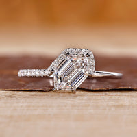 Hexagon cut engagement ring with round cut side stone.
