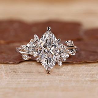 Marquise cut diamond ring with round side stones.
