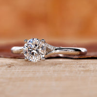 Trellis setting diamond ring with a round brilliant center.
