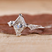 compass prong setting on lozenge cut diamond ring.
