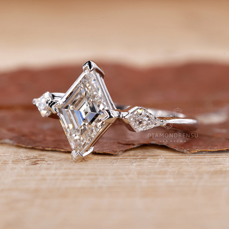 compass prong setting on lozenge cut diamond ring.
