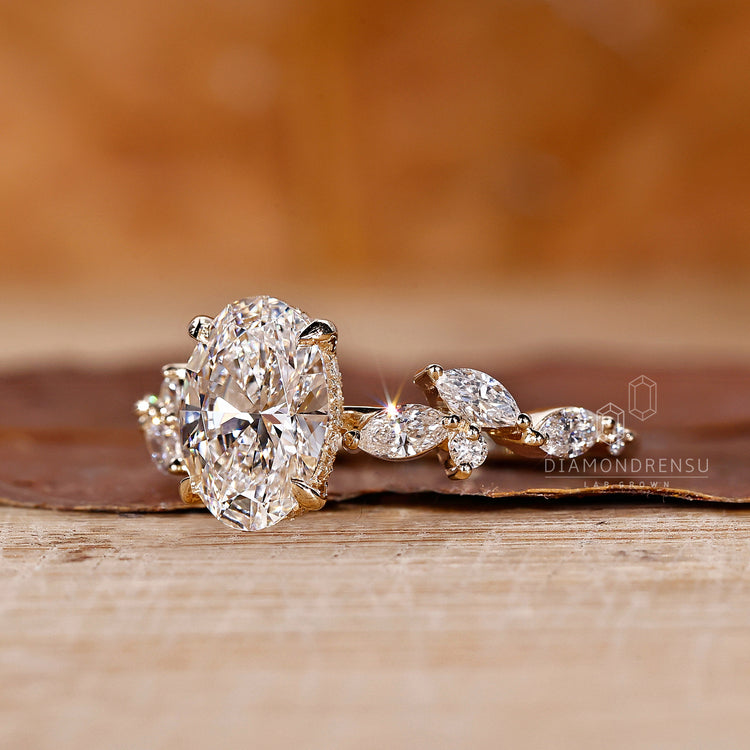 Hidden halo engagement ring with oval diamond and side stones.
