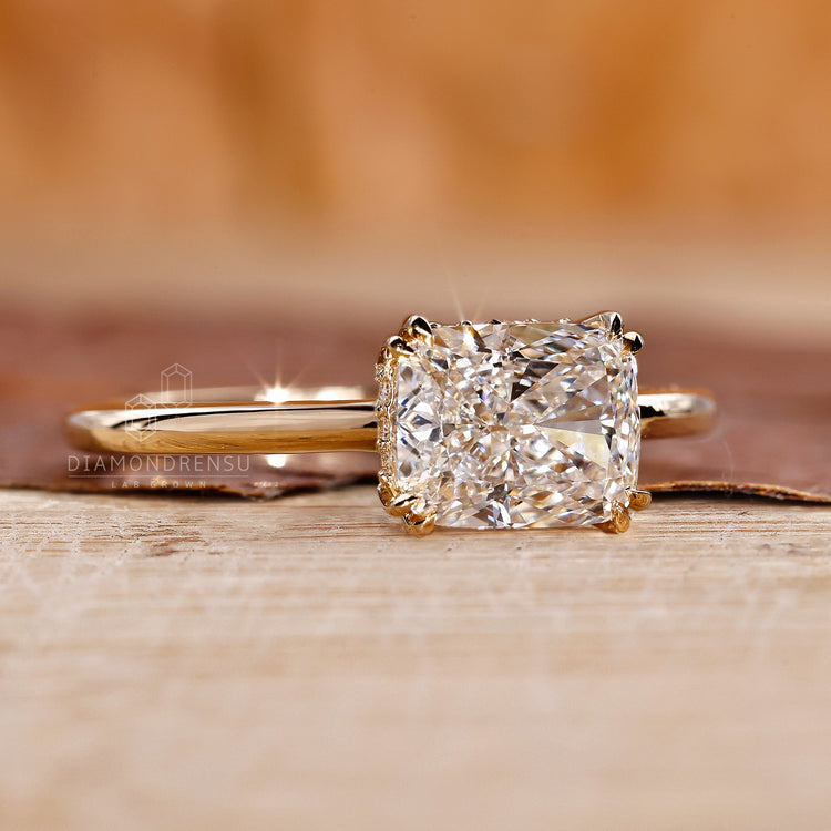 Hidden halo diamond ring with elongated cushion centre stone.
