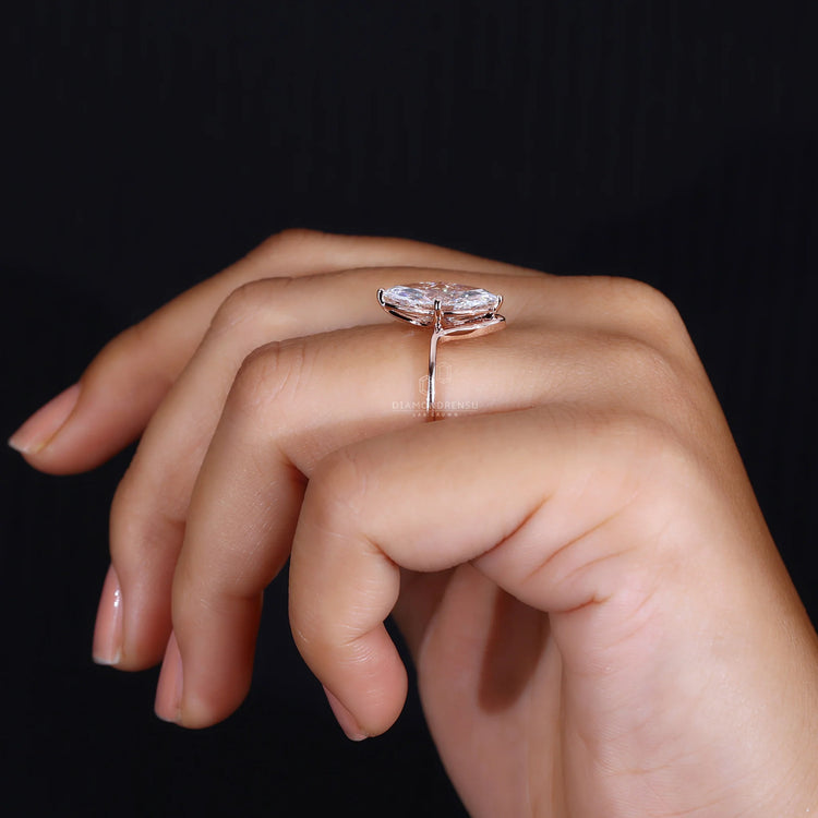 Rose gold ring with a marquise diamond and unique prong setting.
