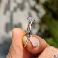 Round moissanite ring with round side stones.