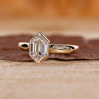 Bezel set ring with hexagon cut diamond.
