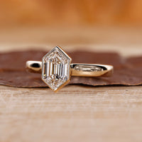 Bezel set ring with hexagon cut diamond.

