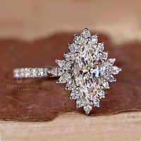 Round diamond halo ring with pavé band in white gold.
