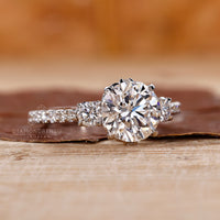 Milgrain setting 3 stone ring with round diamonds in white gold.
