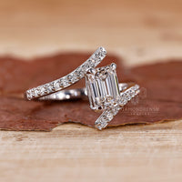 Prong setting holding a lab grown emerald in a custom diamond ring.
