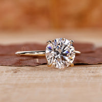 yellow gold engagement ring with round diamond centre.
