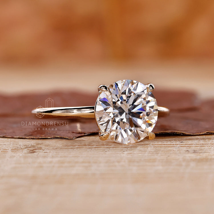 yellow gold engagement ring with round diamond centre.
