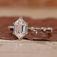 round diamond side stones in hexagon step cut ring.
