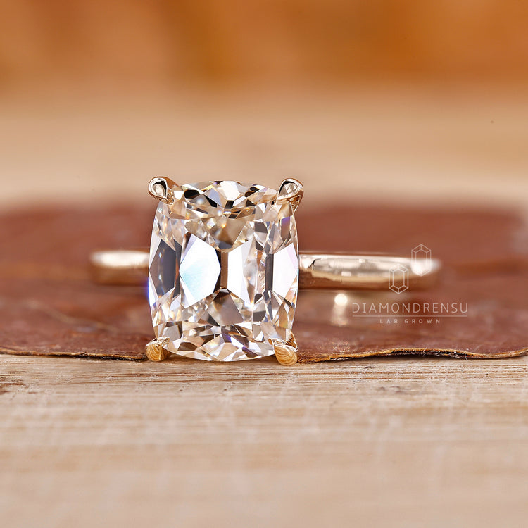 4 claw prong setting in old mine cushion cut diamond ring.
