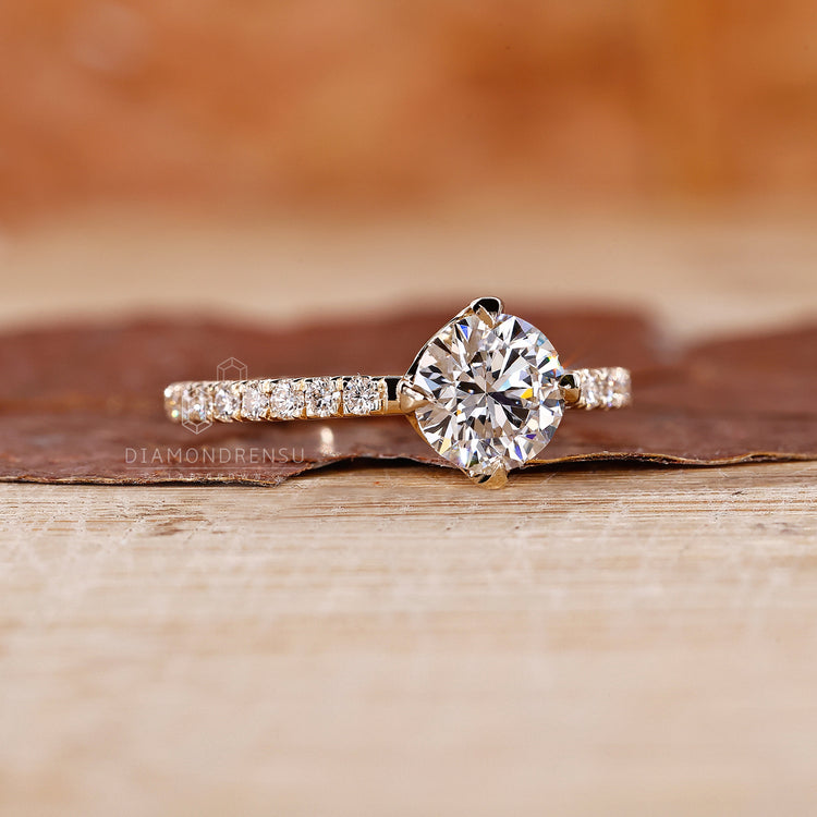 Round cut diamond ring with compass prong setting.
