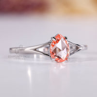 Four claw prong setting ring with pink pear diamond centre.
