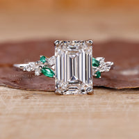 Muse setting ring with emerald cut diamond in white gold.
