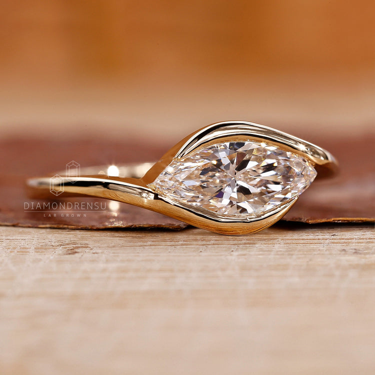 East west marquise ring with a stunning half bezel setting for added security
